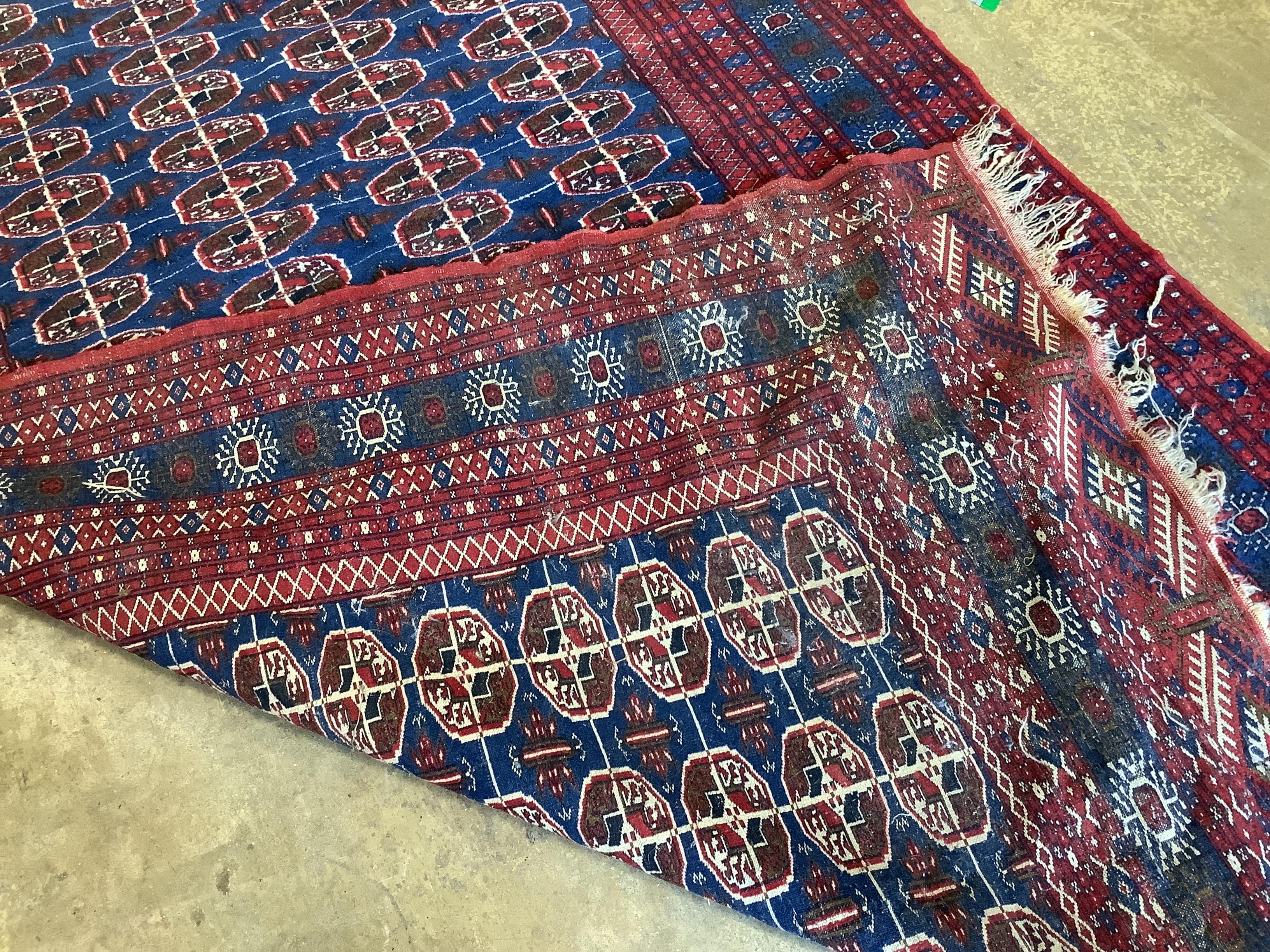 A Bokhara blue ground rug, 240 x 155cm